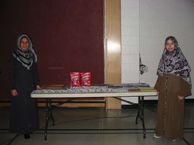 Sarah Khan, OSP 09-10 Co-Head Coordinator (left) and Asna Ahmad, OSP 09-10 Senior Advisor (right) at the OSP Awards Table. The OSP Team presented awards to the entire school and to the grade which raised the most funds towards ISNA High School's project to start their own orphan sponsorship program.